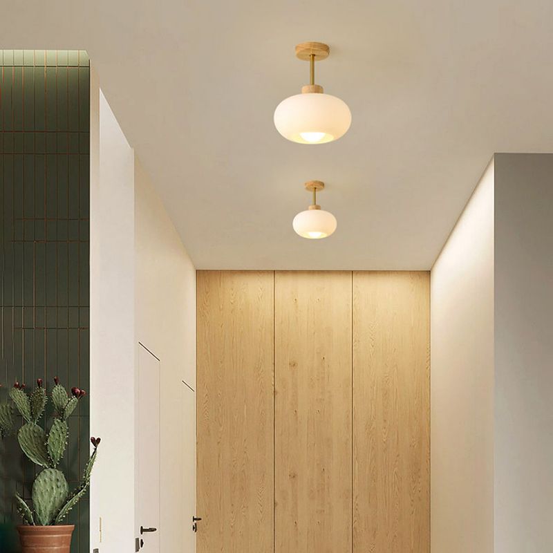 White Hailie lights above a corridor with pale wood cabinetry