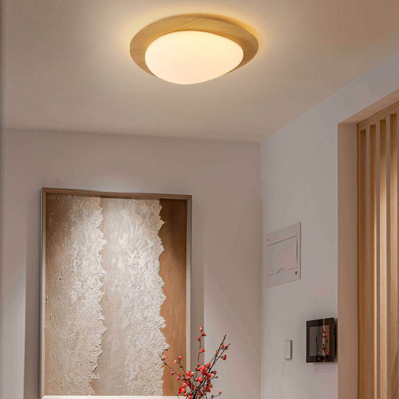 Natural-finish Quinn ceiling light above a room with framed artwork