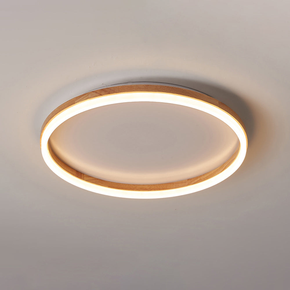 Ozawa wood-ring ceiling light illuminated against a plain ceiling.