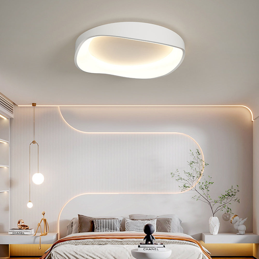 Single white Arisha bowl above a bed, ribbed wall with curved light line, gold globe pendants and yellow-toned cabinets.
