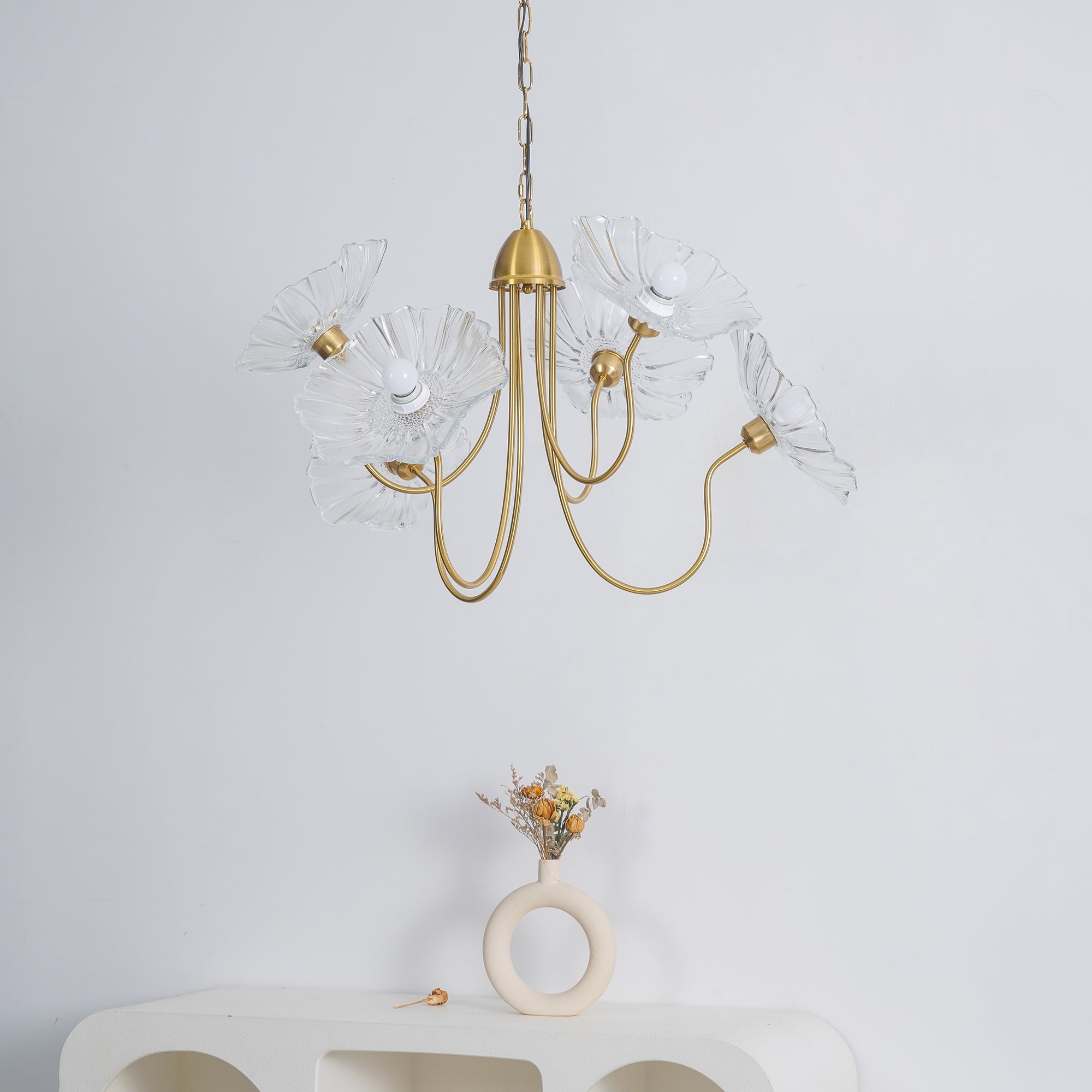 Unlit clear flower chandelier above console