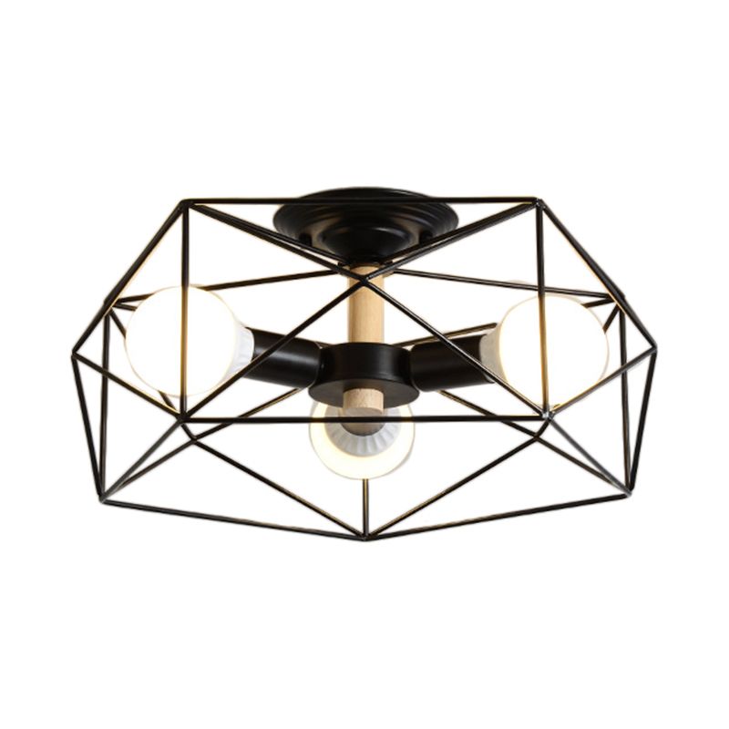Closer view of Black three-light Cooley on white, showing the open polygon frame, example bulbs and pale wood-toned short stem.