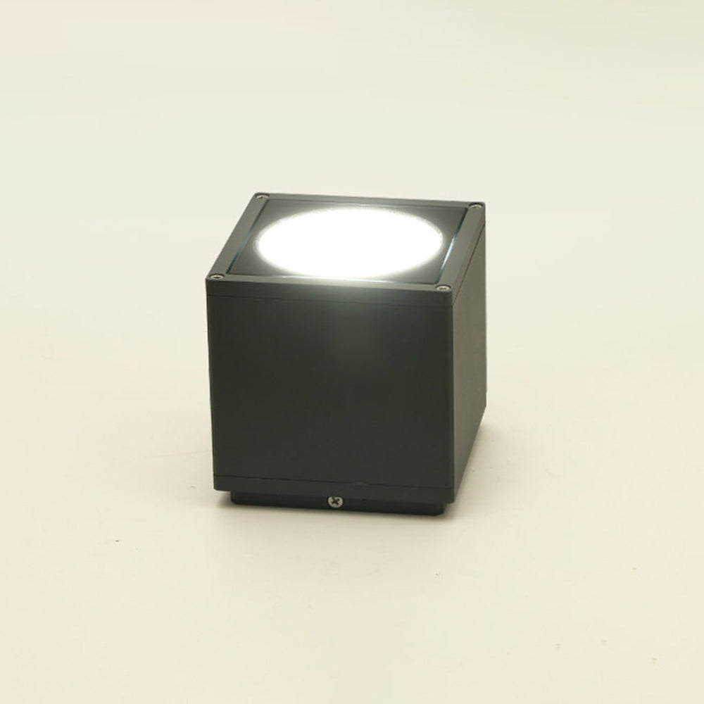 Black Orr cube on a pale background with a bright glowing round face, corner screws and a lower seam.