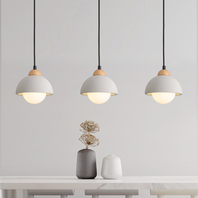 Three Ozawa dome pendants displayed in a row above a console table.