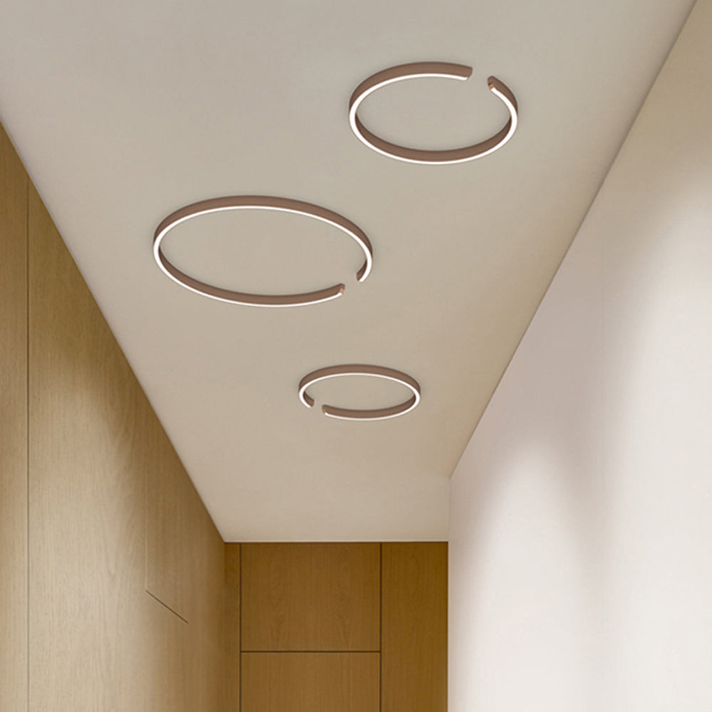 Three Edge ring lights pictured along a wood-paneled corridor ceiling
