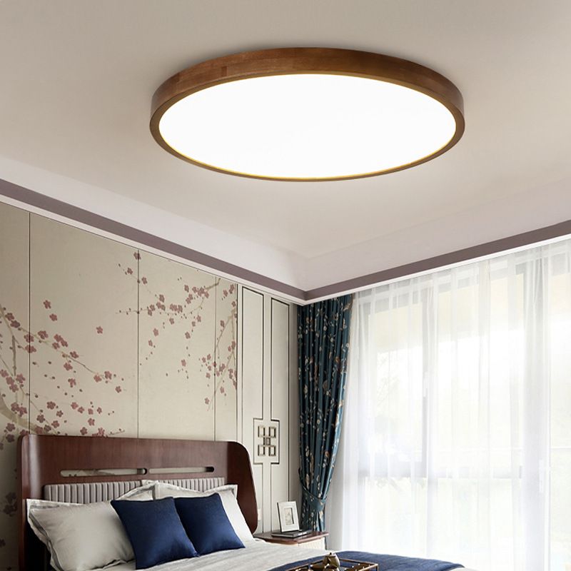 Round Style A Ozawa light above a wood headboard, floral wall, dark patterned curtains and navy pillows.