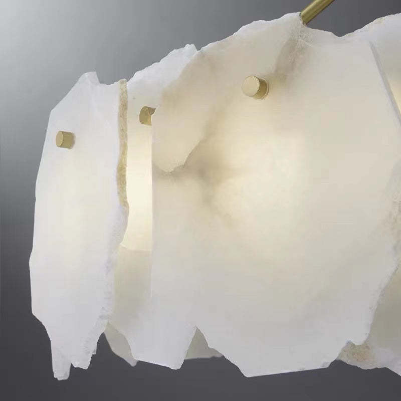 Close view of pale uneven marble piece with small round fasteners