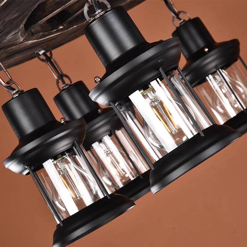 Close view of the Austin lantern fittings with dark metal tops and clear glass cylinders.
