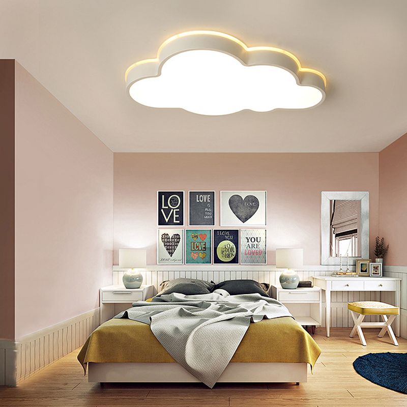 Minori cloud ceiling light above a bed with mustard bedding, Love artwork, pale bedside lamps and a white vanity.
