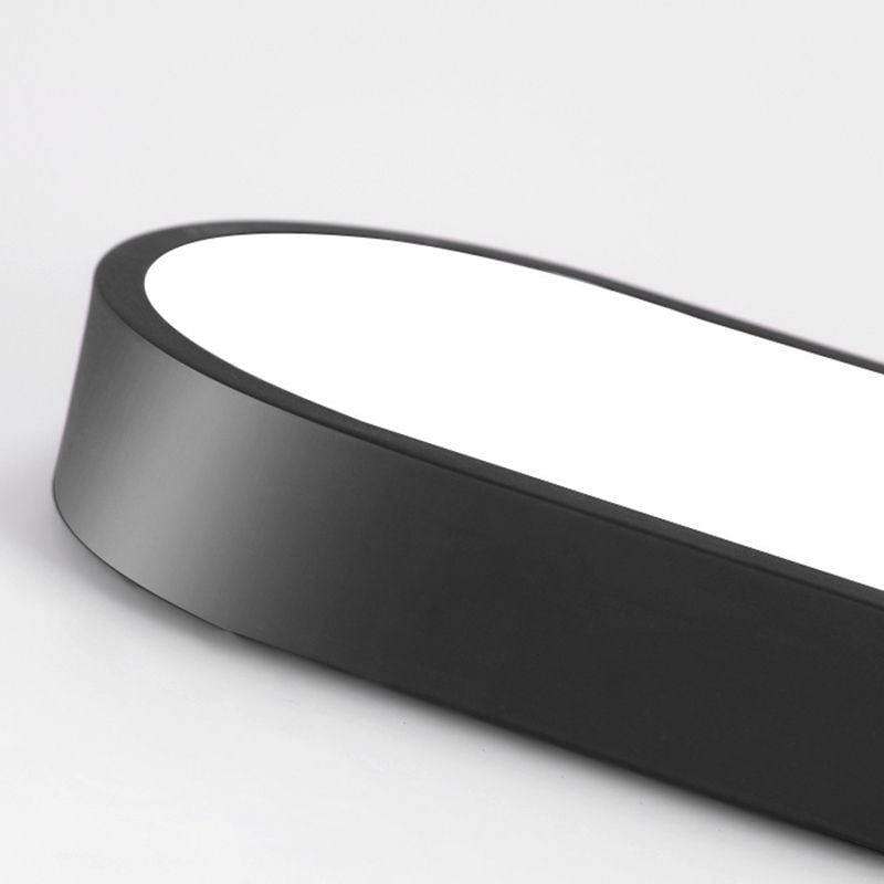Oblique detail of a black Quinn light with a broad smooth sidewall, rounded end and filled pale lower face.