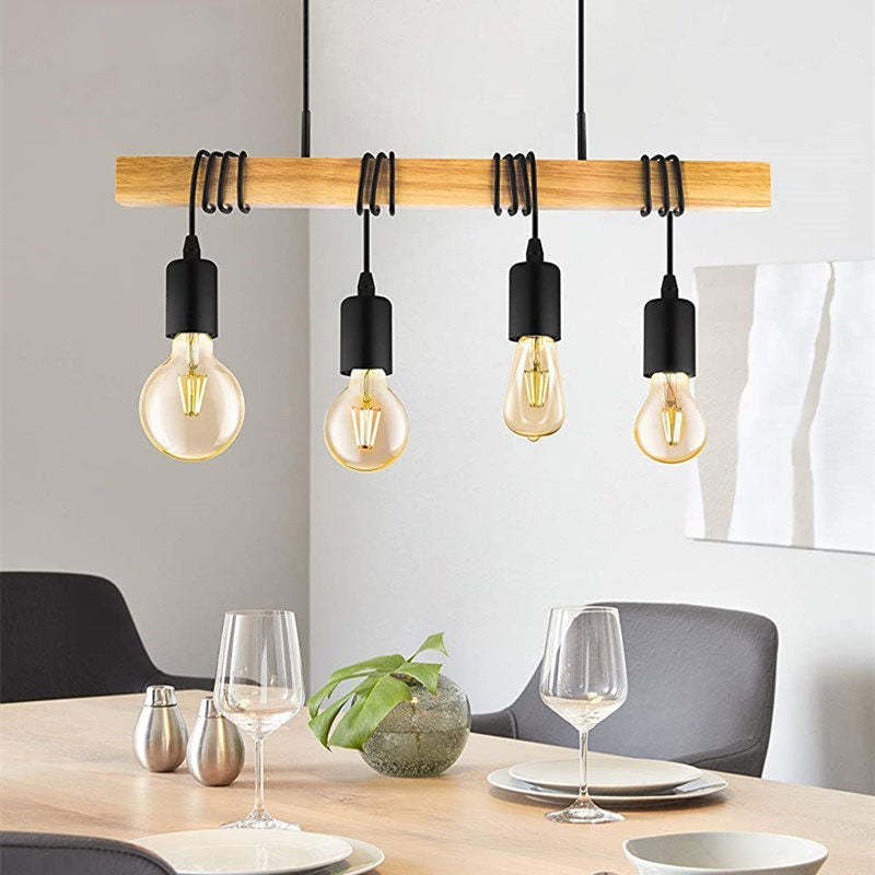 Four-light Alessio wood pendant above a dining table with dark chairs.