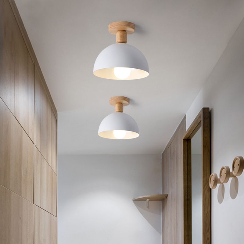 Two white Ozawa Dome lights in hallway with tall wood cabinet, mirror, circular wall hooks and corner shelf
