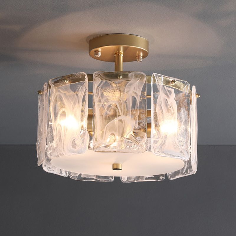 11.8-inch Kirsten option with lit example bulbs behind patterned glass panels, a gold-toned stem and pale bottom plate.