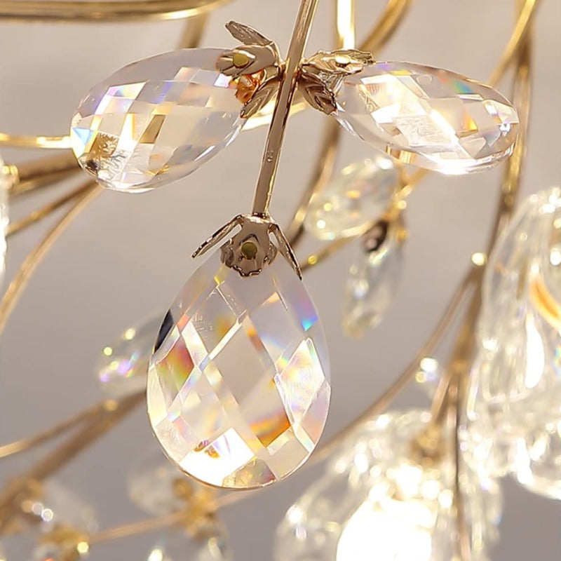 Close-up of Lili faceted clear leaf and teardrop ornaments attached to gold-tone stems, with rainbow-like reflections.