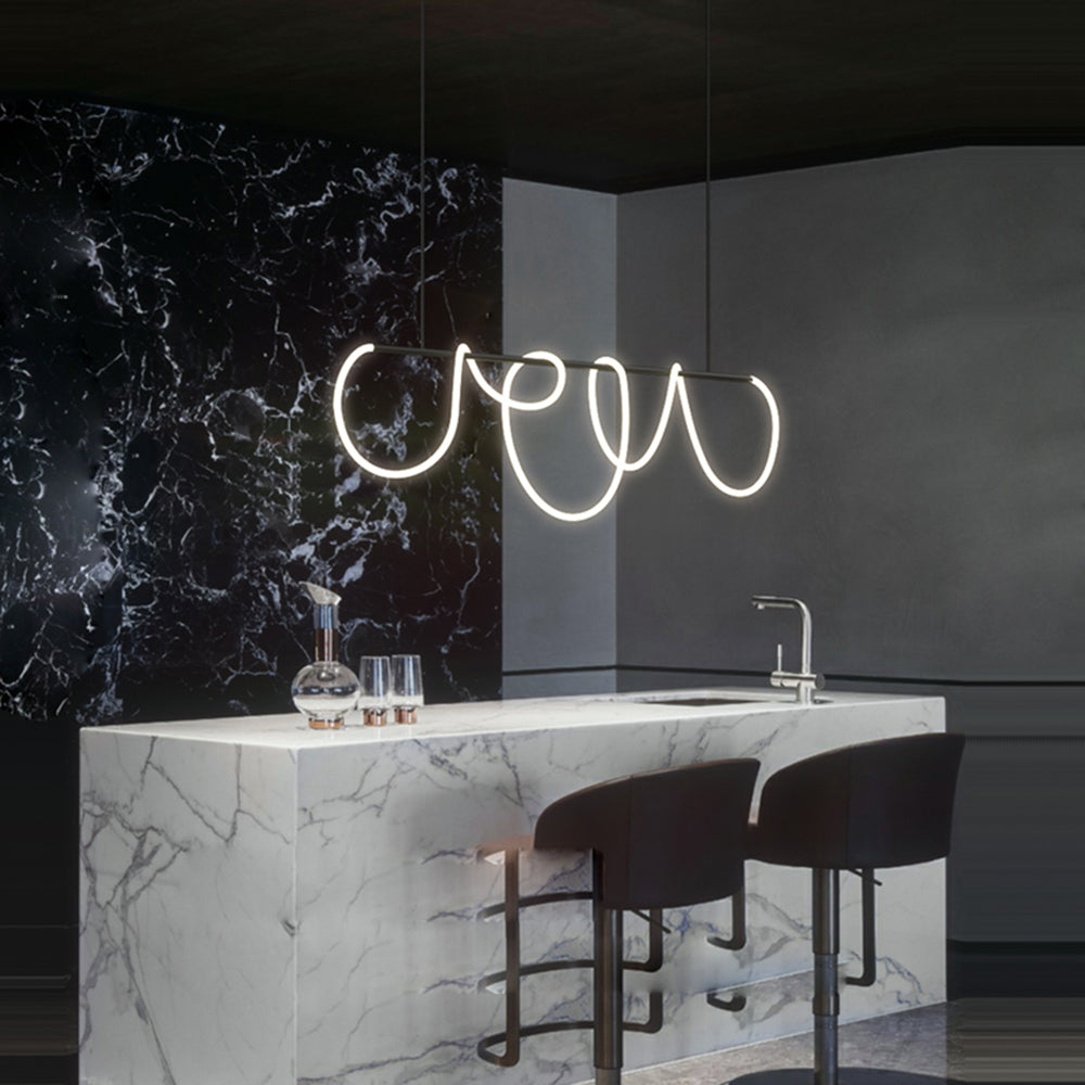 Black Louise linear light above a veined white kitchen island with a tap, glassware and stools, against a black veined wall.