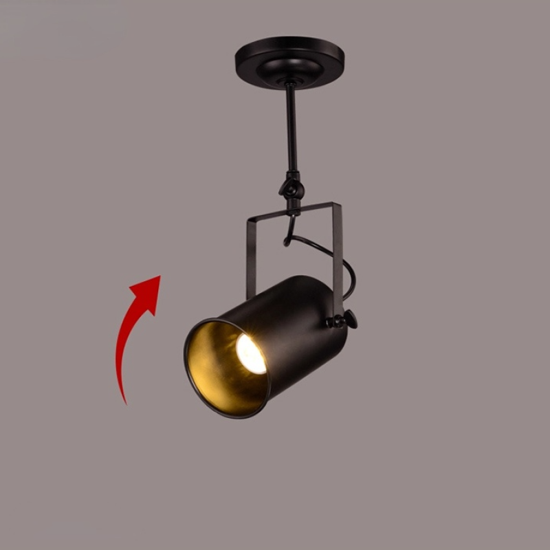 Alessio single-head cylindrical spotlight with square bracket, lit opening and a red arrow illustrating head tilt.