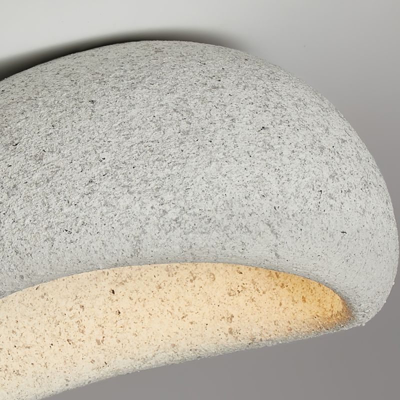 Close-up of a pale speckled Byers shell and its curved inner opening with a warm-looking glow.