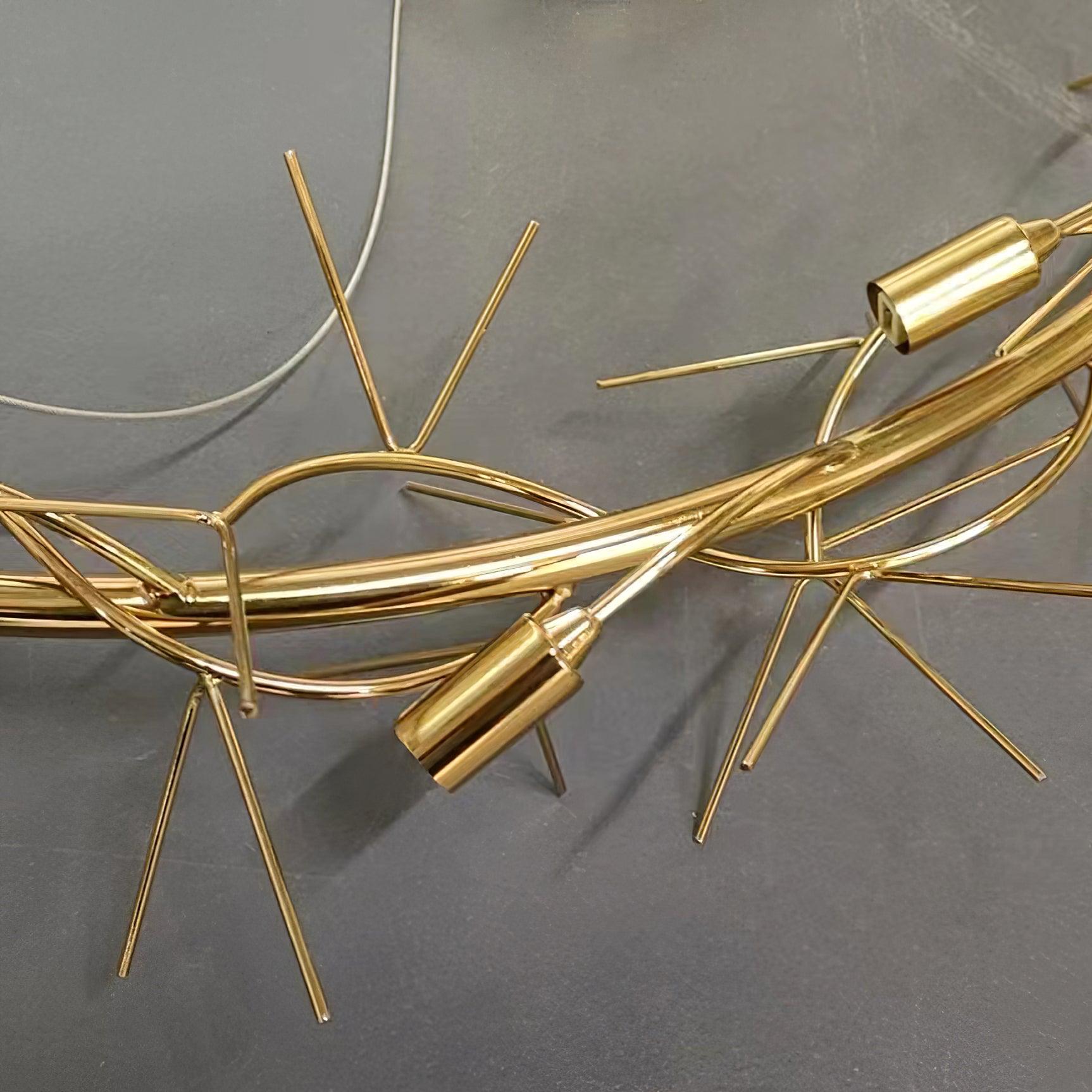 Bare gold-colour chandelier frame and branches before leaf assembly
