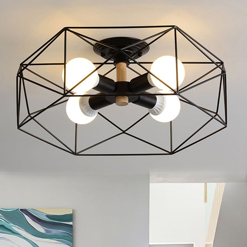 Black four-light Cooley polygon lantern with lit bulbs and a pale wood-toned stem, above teal wave-pattern artwork.