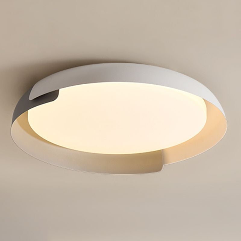 Angled close view of a gray and light Quinn rim around a warm-lit circular face against a gray ceiling.