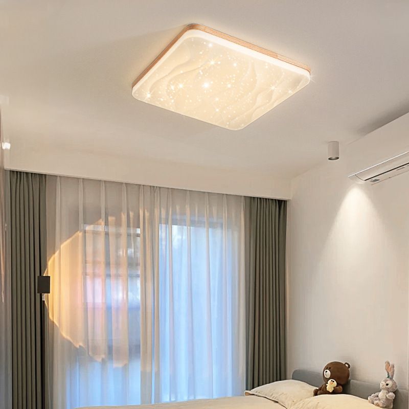 Square Ozawa rippled light face above a gray sofa-bed with teddy and rabbit toys, beside curtains, a ceiling spotlight and an air conditioner.