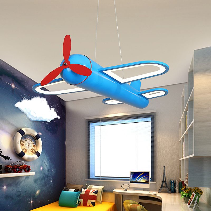 Blue Minori airplane pendant illuminated in a space-themed bedroom.