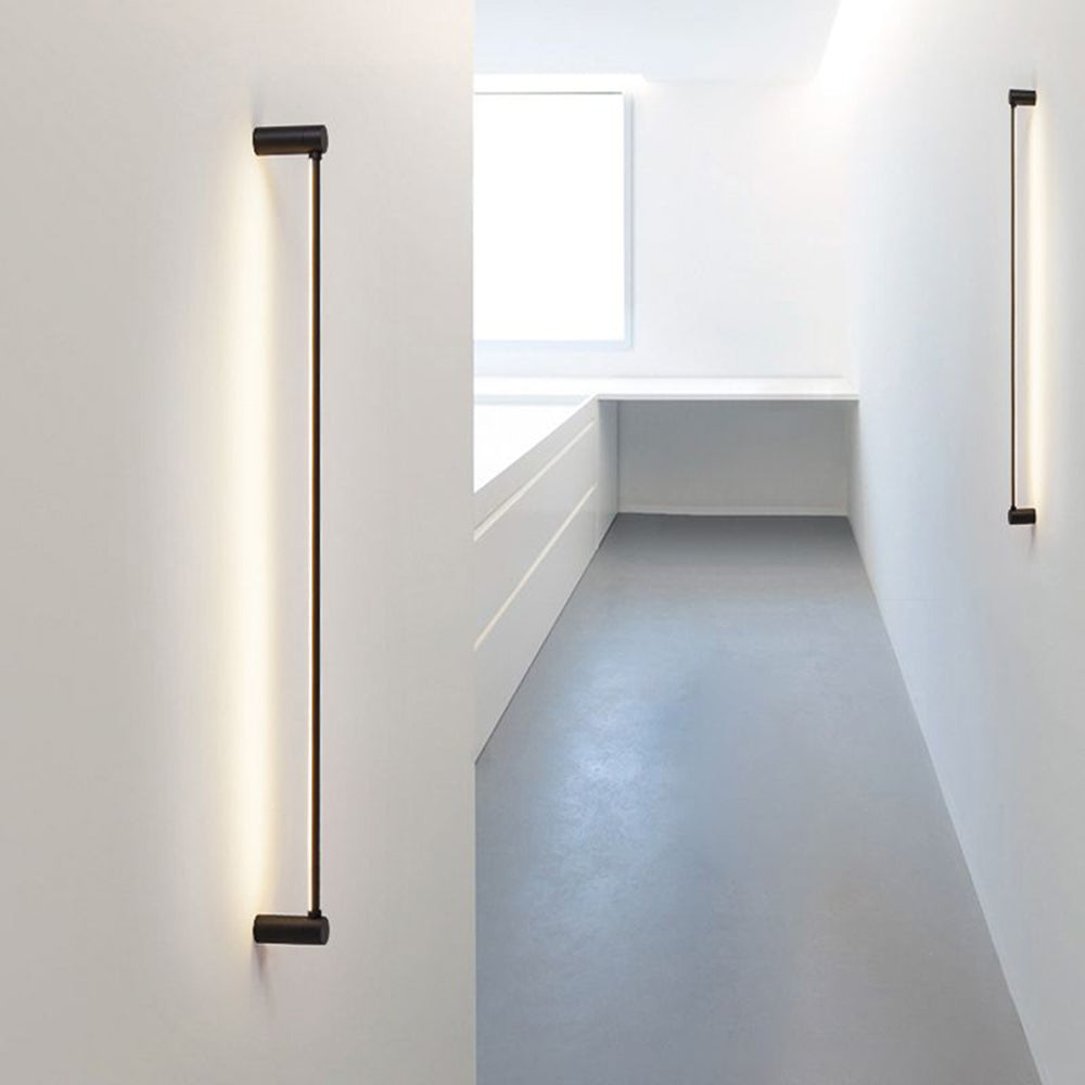 Two separate Edge bars mounted vertically on opposite pale corridor walls beside windows and a grey floor.