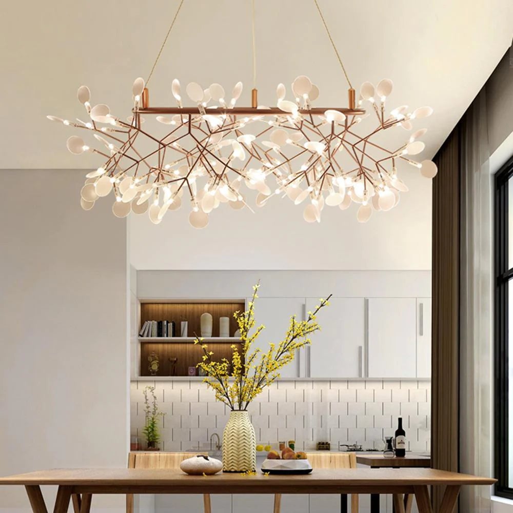 Linear rose-colour firefly chandelier above a kitchen island