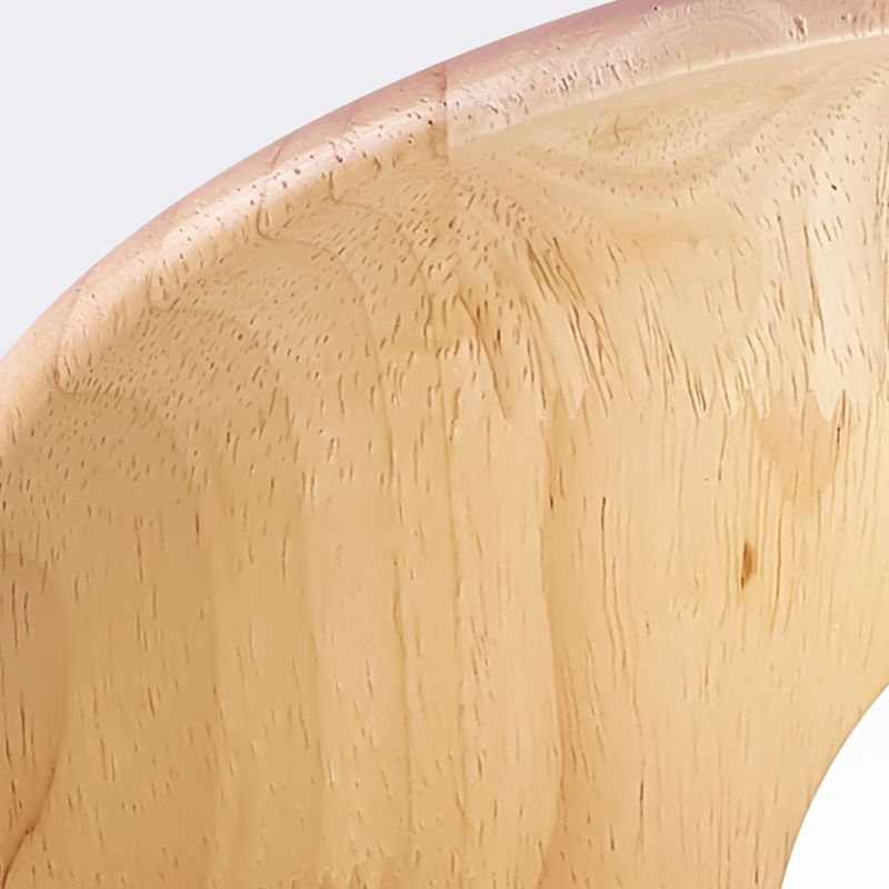 Tight detail of the curved edge and visible grain on the pale wood underside of a Carins disc.