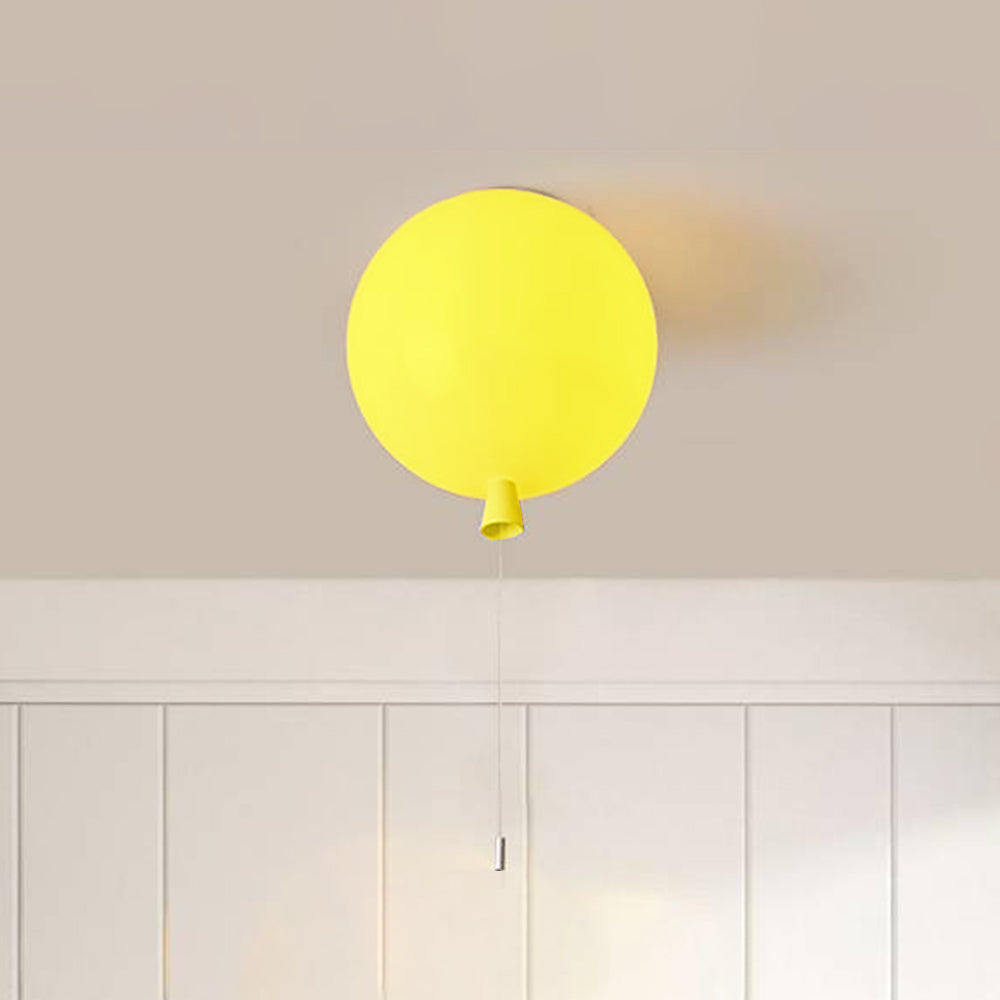 Yellow Fateh balloon fitting at a pale ceiling, showing the rounded shade and tapered lower neck detail.