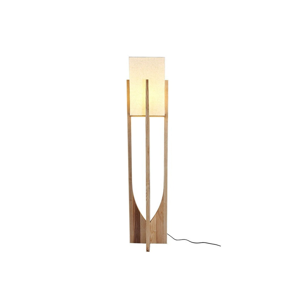 Isolated tall light wood-tone Ozawa floor lamp with cream rectangular shade, curved crossed panels and visible black cord