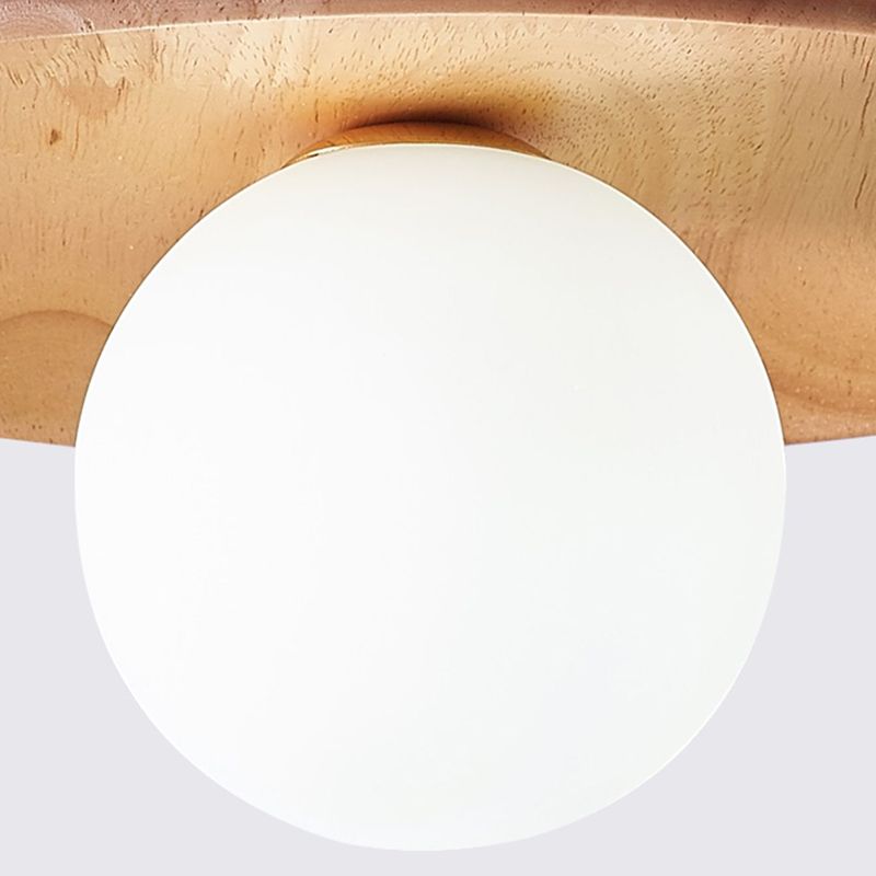 Close white globe extending beneath the centre of the Carins wood disc, with the wood-grain underside visible.