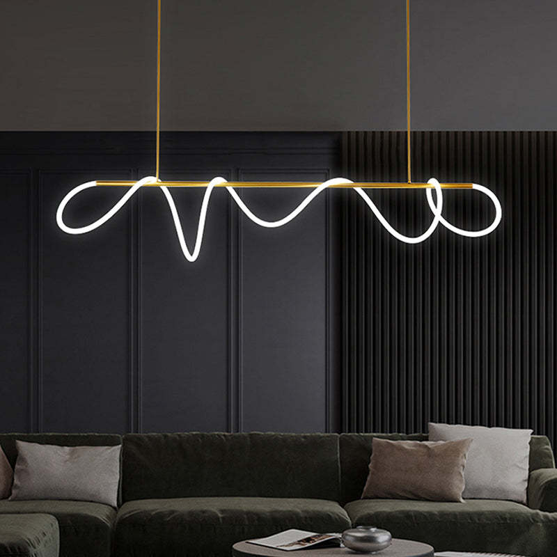 Gold Louise straight bar with luminous loops above a dark green sofa, pale cushions and round coffee table, against dark panels.