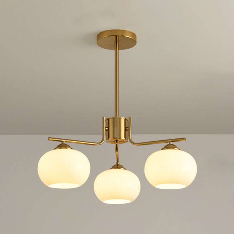Valentina three-light brass-finish chandelier with rounded glass shades