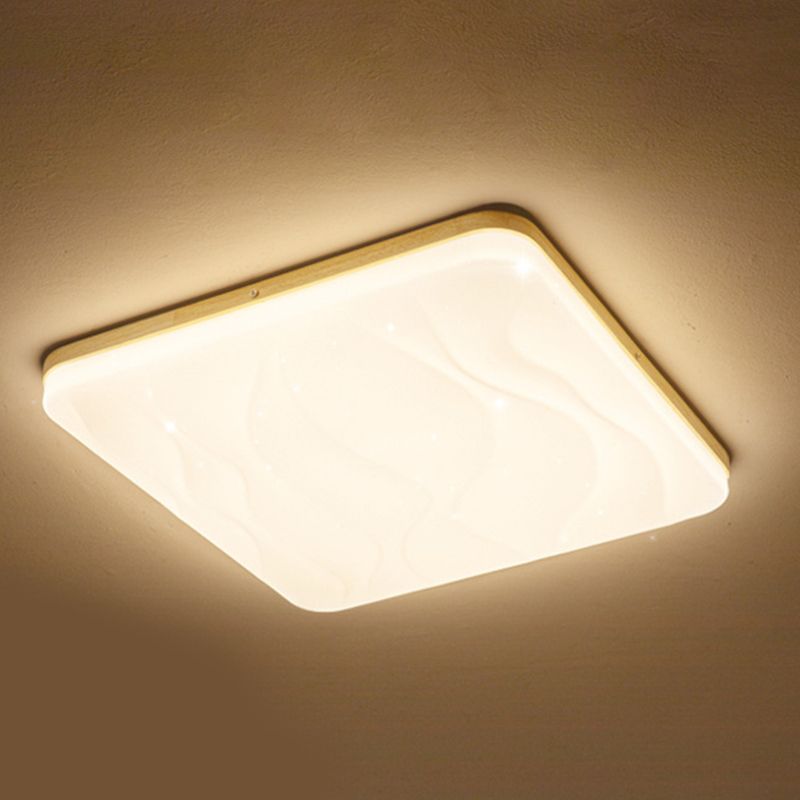 Low-angle close view of a square Ozawa bright face with raised flowing ripples, a wood-tone upper rim and a warm halo on the ceiling.
