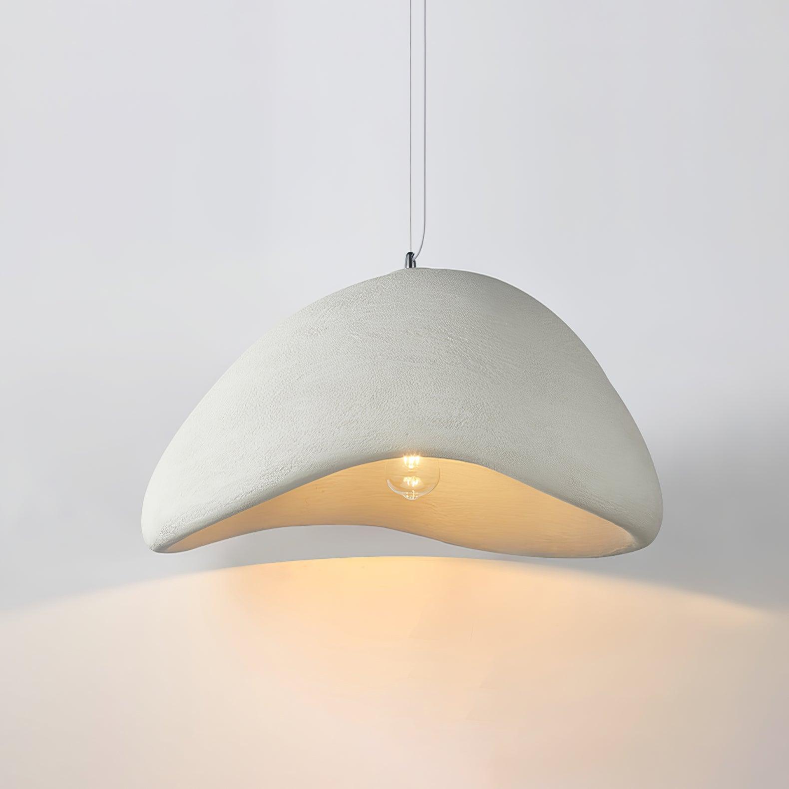 White finely textured cloud-shaped pendant with a round visible bulb and warm-looking open underside on a pale background