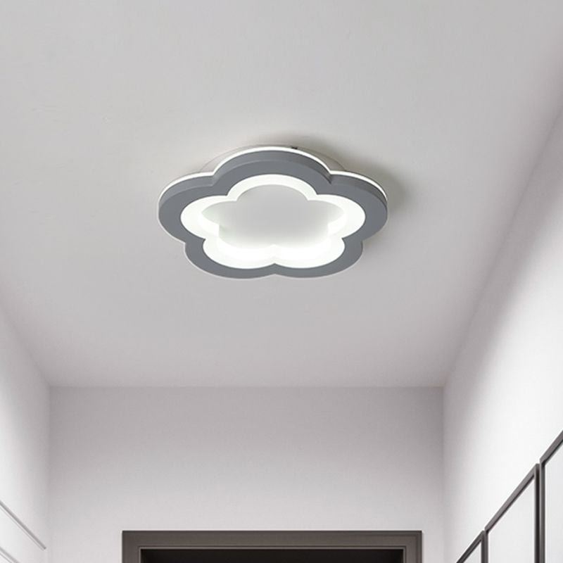Five-lobed flower gray ceiling light with a white-lit outline in an indoor hallway