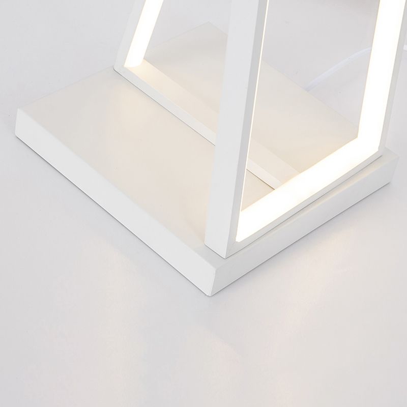 Close-up of the white rectangular base and lower crossed-triangle frame with lit strips