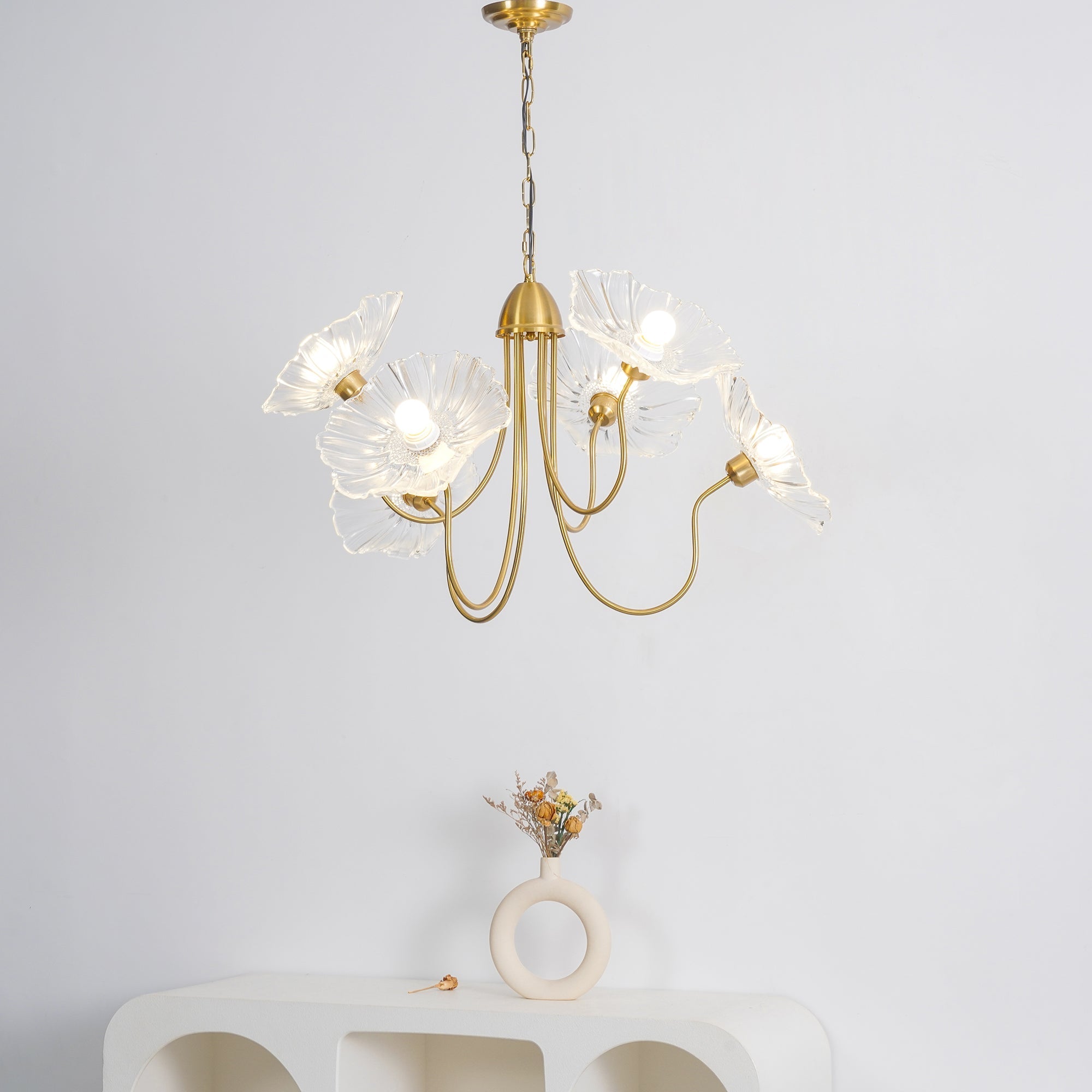 Clear flower chandelier above a console