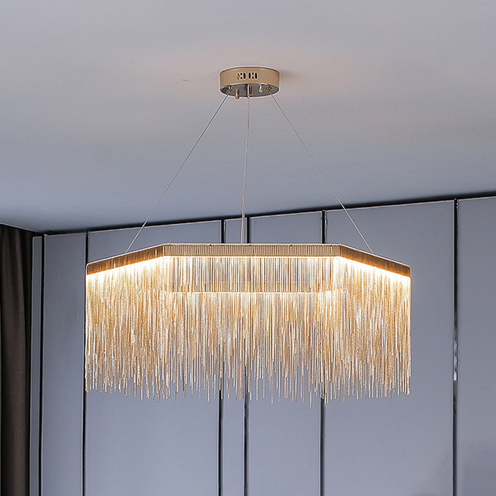Gold single-tier Colon chain-fringe pendant illuminated in a room