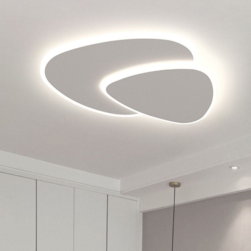 Quinn lit white ceiling light above white cabinet panels beside a grey wall and a separate slim hanging lamp.