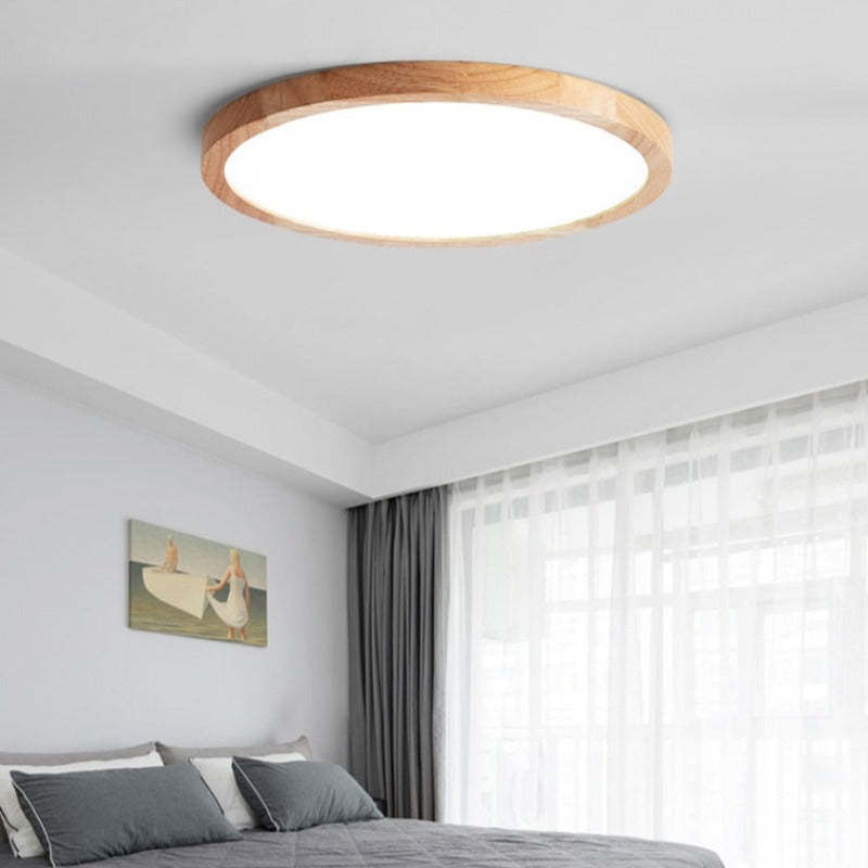 Ozawa ceiling light with a pale wood-grain rim above a gray bed