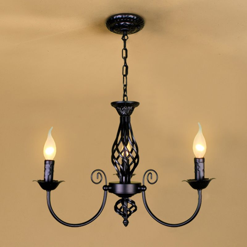 Black Silva three-light chandelier with round ceiling canopy and chain, two outer candle holders and central glow in warm-toned room