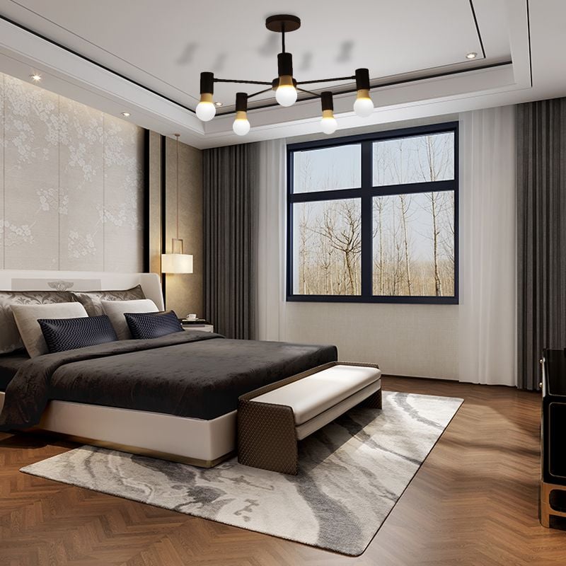 Black five-light ceiling fixture above a bed and bench beside a window with curtains