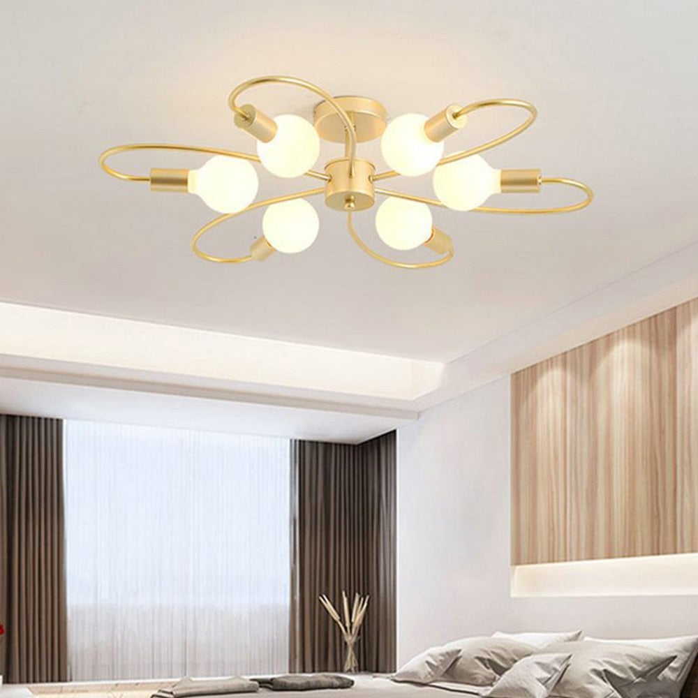 Valentina Gold six-light option above grey bedding, dark side curtains and a light wood panel in a bedroom.