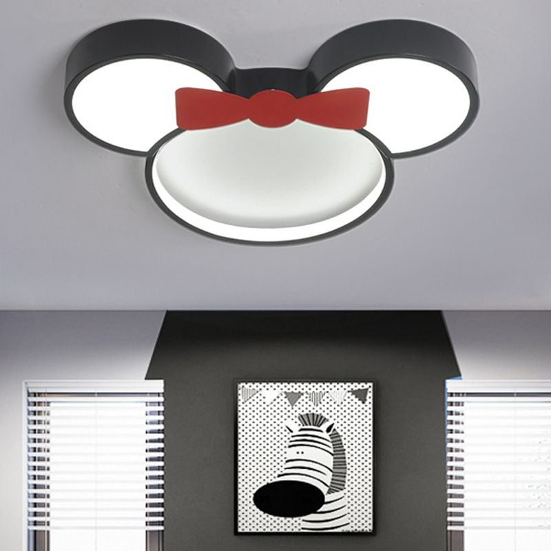 Red-bow Freja mouse-shaped ceiling light illuminated in a bedroom.