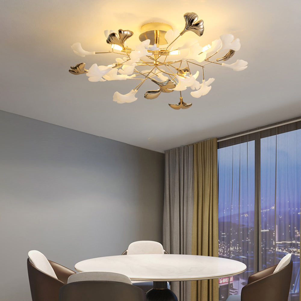 Olivia above a round white dining table and pale chairs, with gray walls, long curtains and a dusk window.