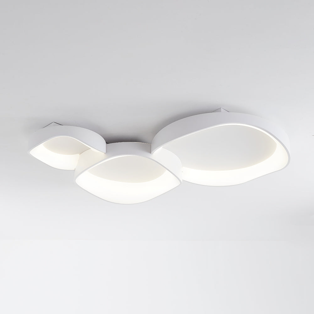Three-bowl Arisha light viewed from below, with white wave rims, cool-looking illumination and visible ceiling-side details.