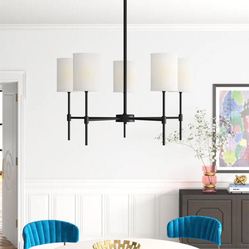 Black fabric-shade chandelier above a table with blue chairs