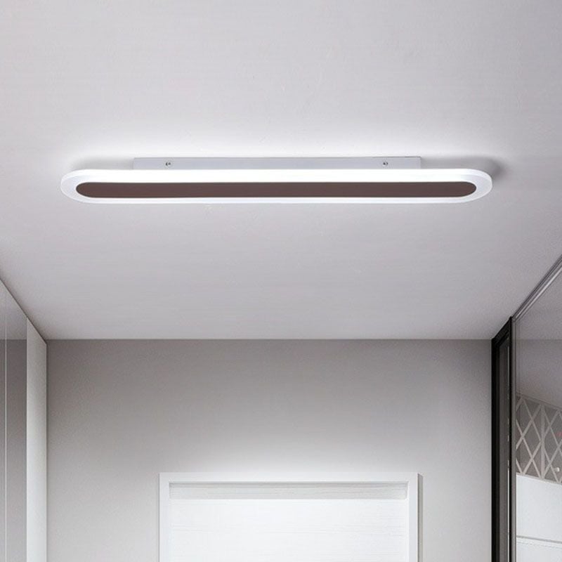 Edge elongated oval ceiling light above an interior doorway